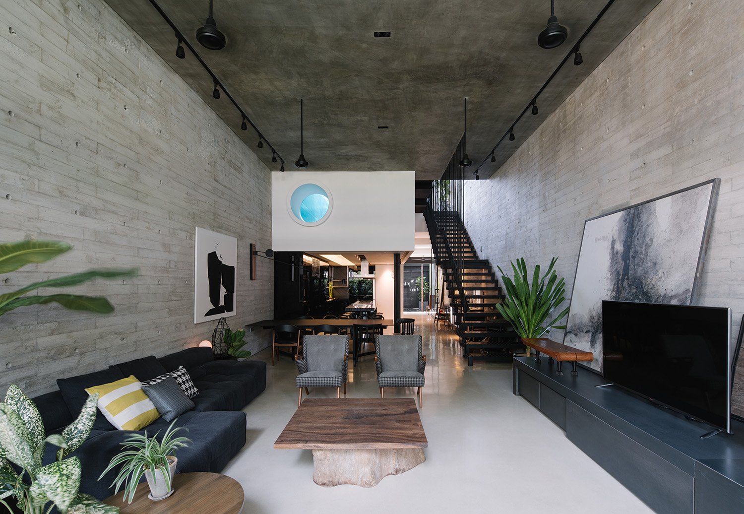 View of living room. The lap pool is suspended over the kitchen. | Marc Tan