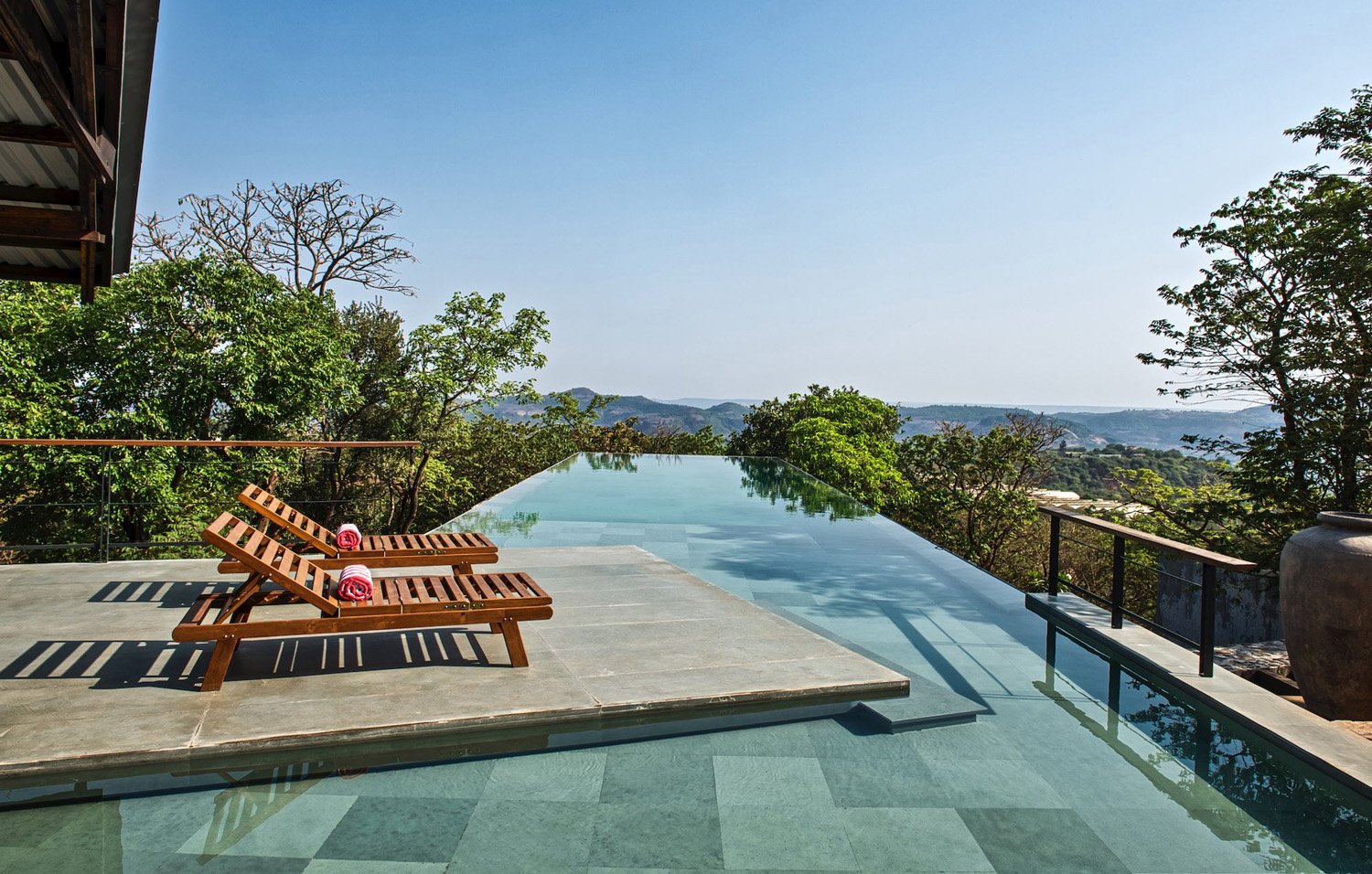 The elevated pool (sleeping spaces below it) extends into the  Forest and connects to the hills beyond | Bharath Ramamrutham