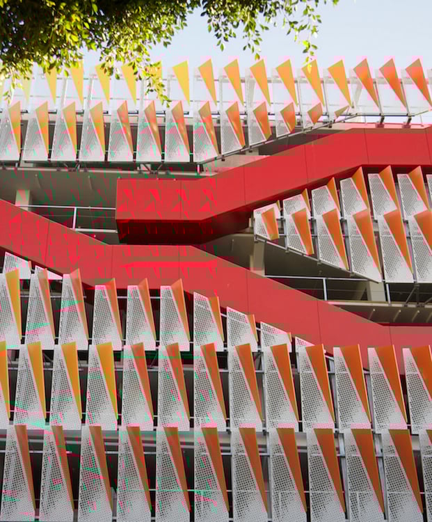 The innovative structure is highly sustainable with exterior staircases and metal façade panels that reflect light into the interior. | 