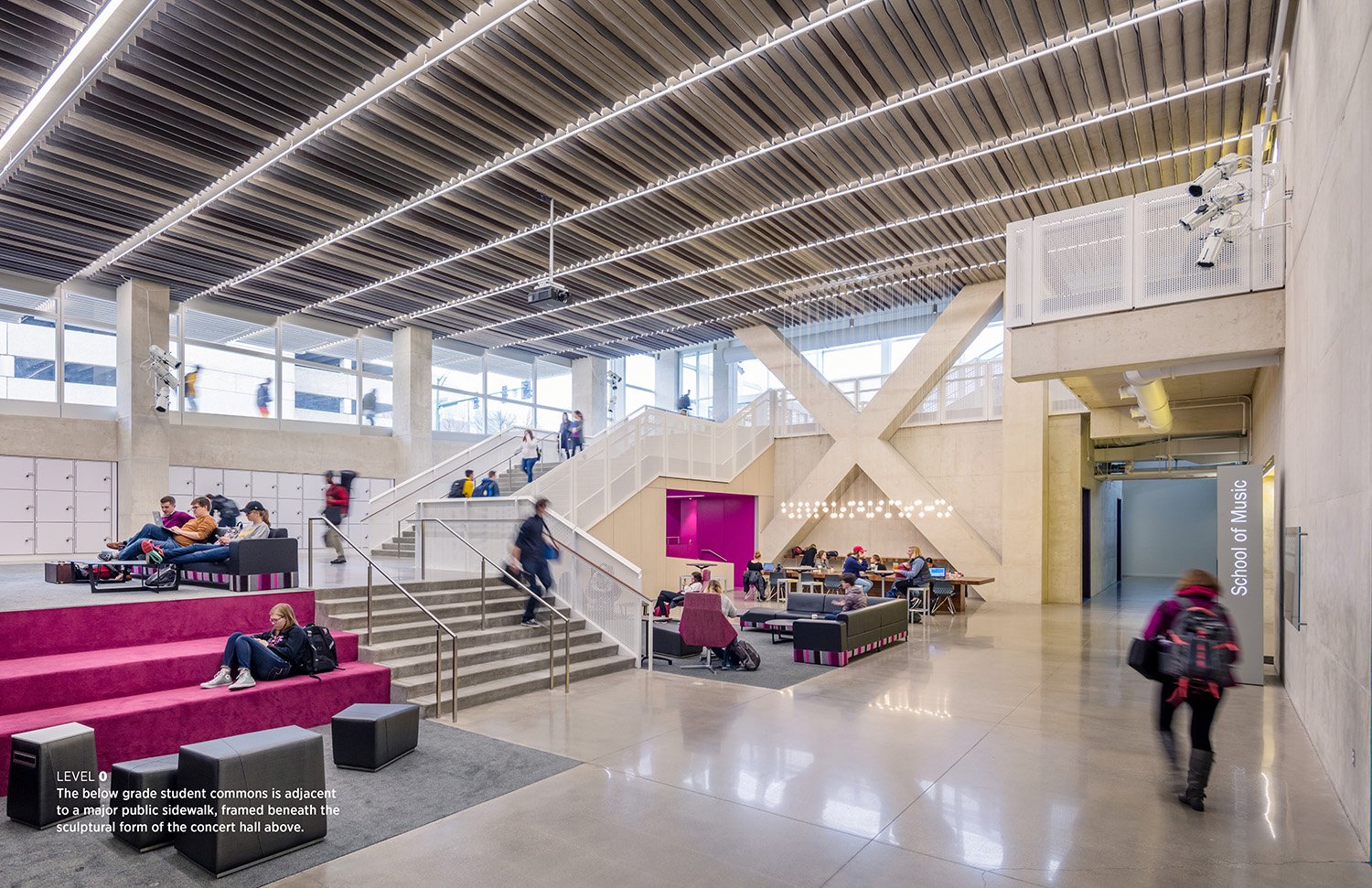The below grade student commons is adjacent to a major public sidewalk, framed beneath the sculptural form of the concert hall above. | Tim Griffith
