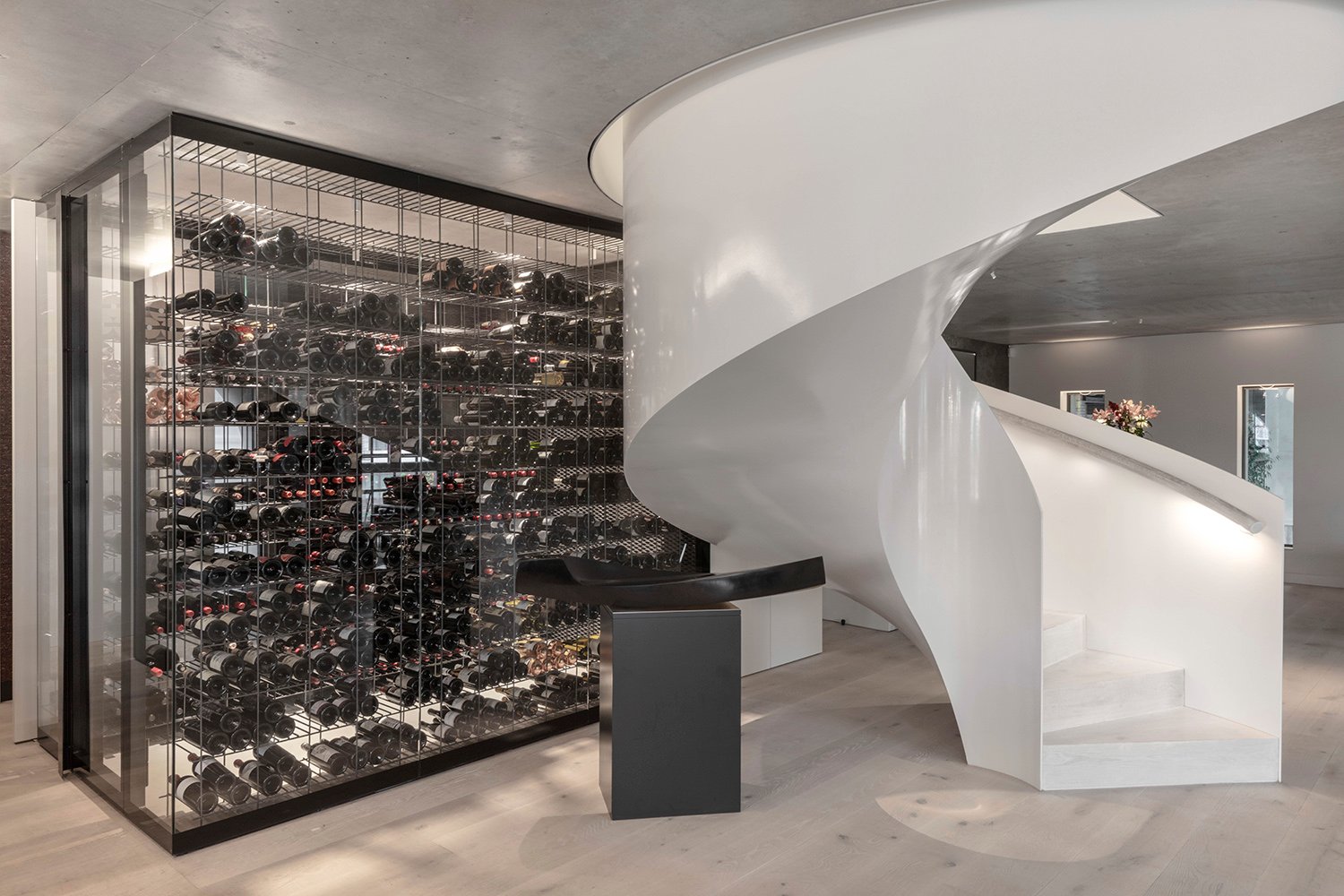 Transparent glass wine room to help bring “lightness” within the space. | Delphine Burtin