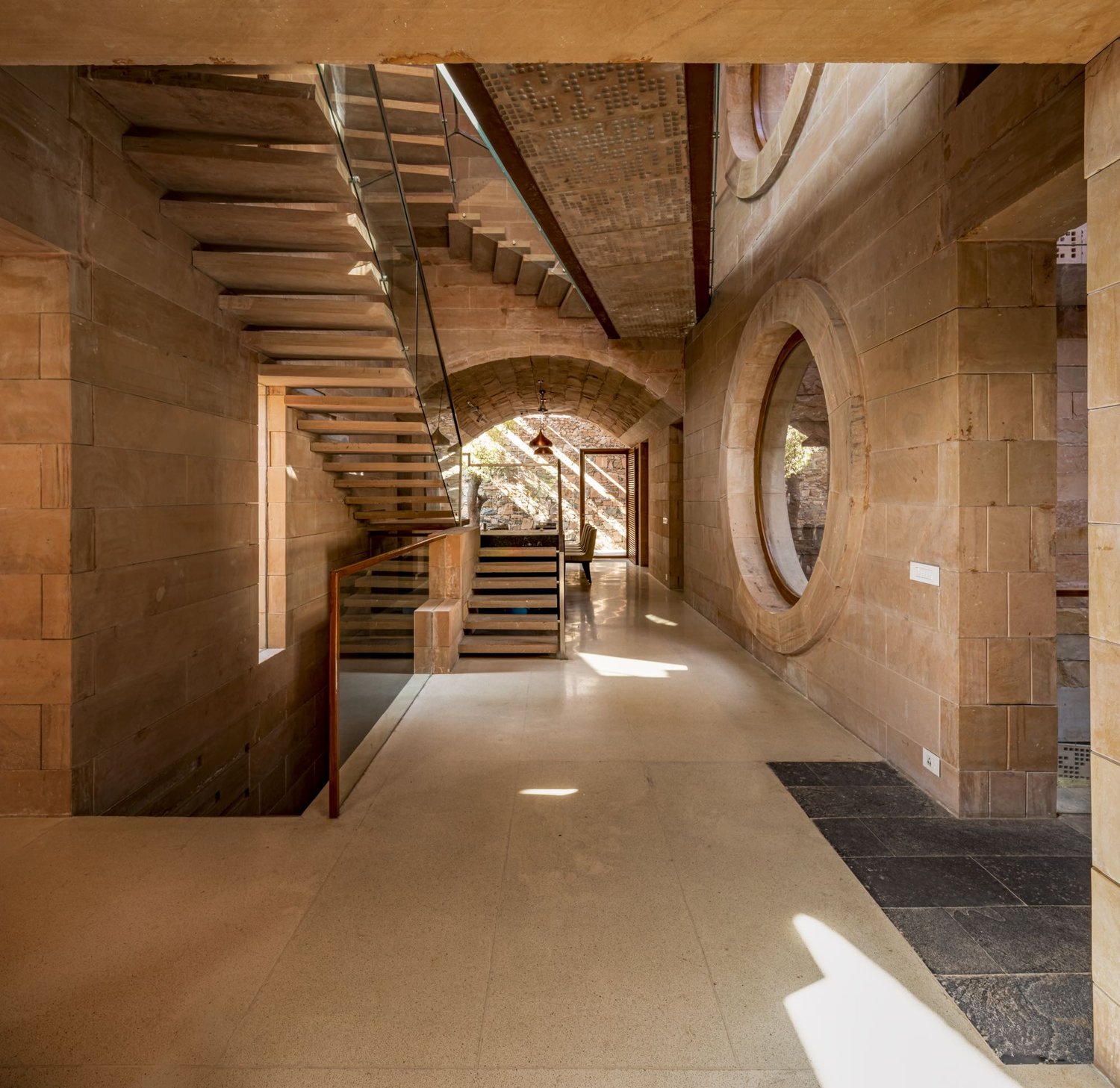 The Central Inner Void binds the house and creates shaded links to its different parts. Within this space, the morphology of the stone building elements are revealed. It has a labyrinthine quality, like a | Bharath Ramamrutham
