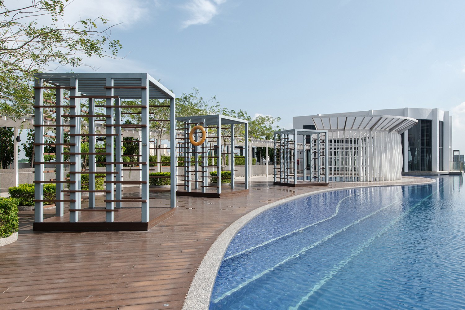 Organic shaped infinity pool and wavy wading pool screening at Level 6 matches the fluidity language of the façade design | David Yeow
