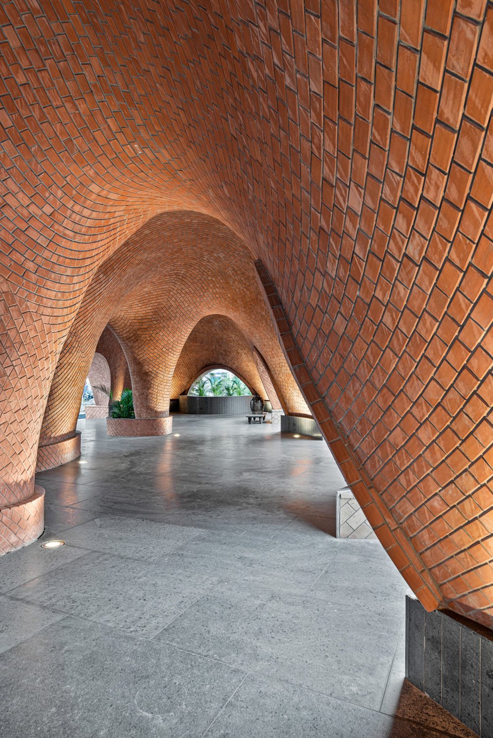 The light and the shadow from the voids and the in between spaces playfully tease the user, brushing past the cornerless realm of walls. The structure engulfs the space, the undulations become the walls, the walls become the enclosure. | PHX India