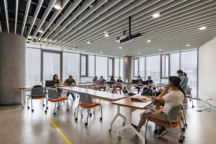 Interior of typical large classroom space with views towards the city and surrounding mountains | Renzo Rebagliati