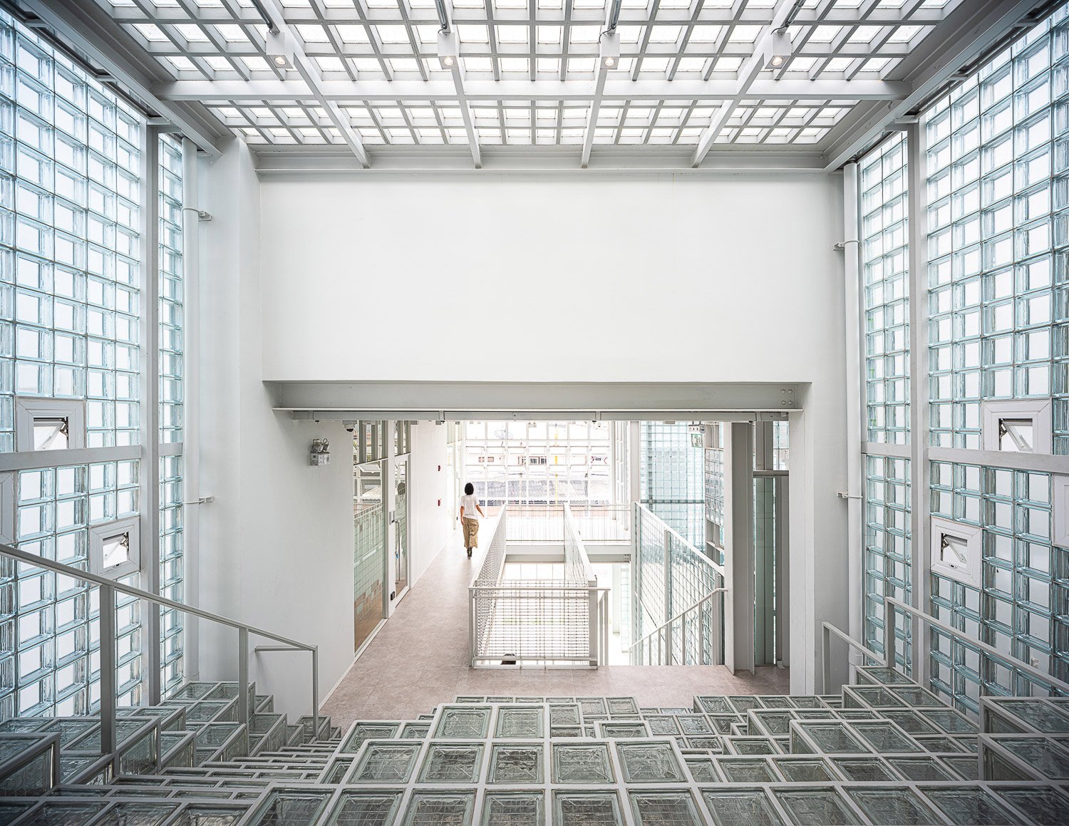 Where’s House Warehouse : An architectural marvel of light and transparency, featuring expansive use of glass blocks in the floors, walls, and ceiling to create a luminous and airy space. | © Spaceshift Studio