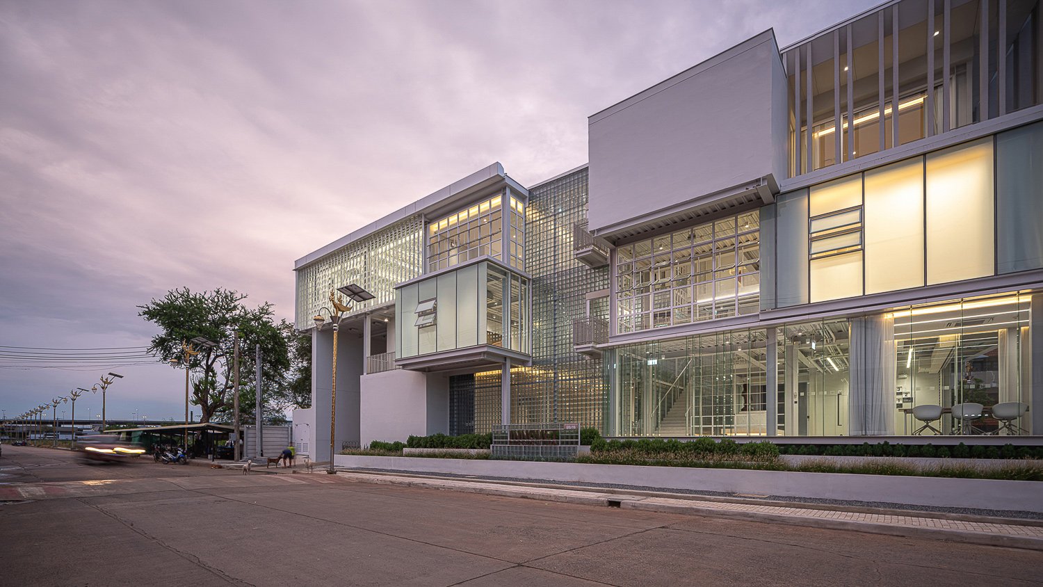 Architectural Overview : The exterior view of Where’s House Warehouse, featuring extensive use of glass blocks that blend aesthetics with functionality, creating a transparent and luminous façade. | © Spaceshift Studio