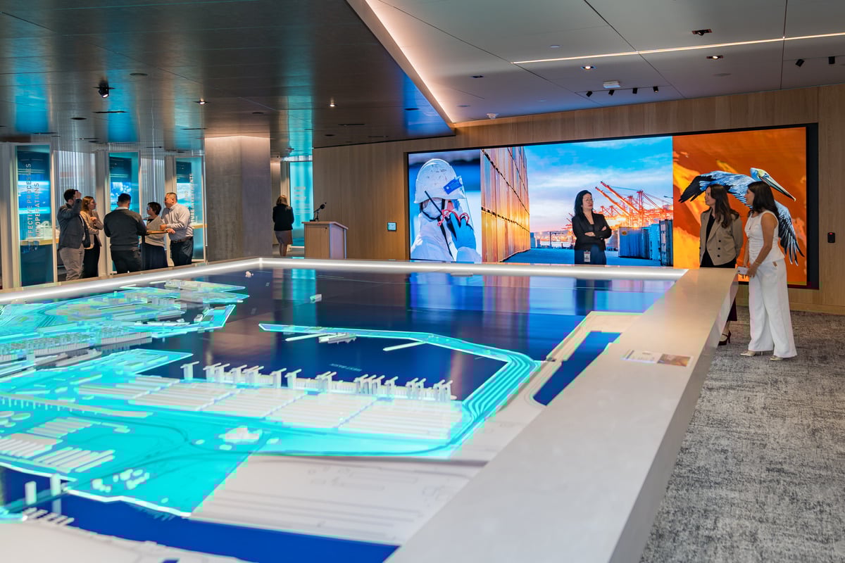 The main exhibit feature at the center of the space is an 18' x 33' 3D map table of the Port of Long Beach which can interface with a large feature screen wall nearby, providing a dynamic visual narrative of the Port’s intricate operations.   Its intricat | Paul Vu