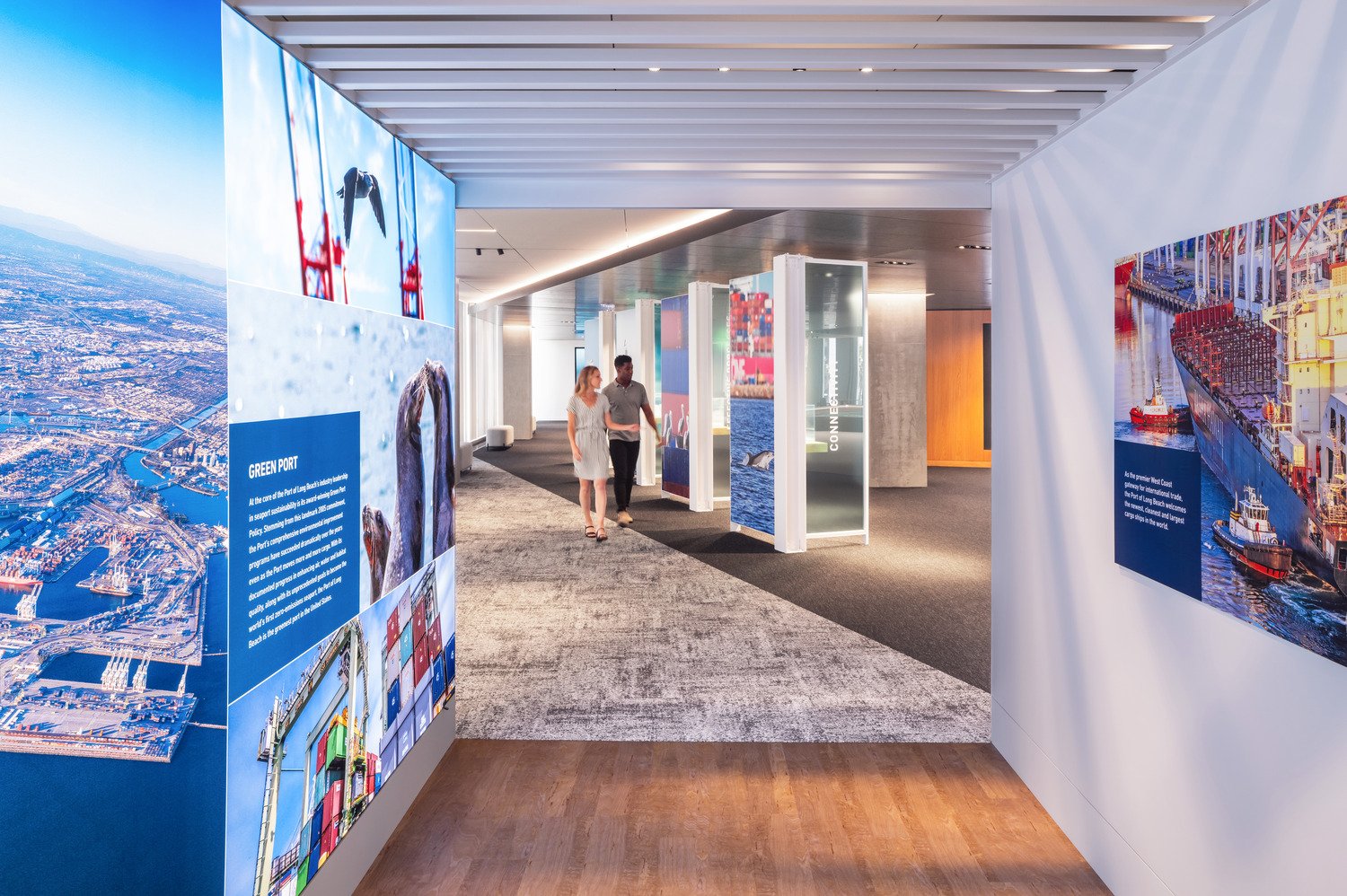 As you step inside the container exhibit, which highlights the Port's dedication to its community, your gaze is drawn to a striking black ribbon that cascades through the space. This leads to the Innovations Exhibit, where 3D models showcase the Port’s gr | Paul Vu