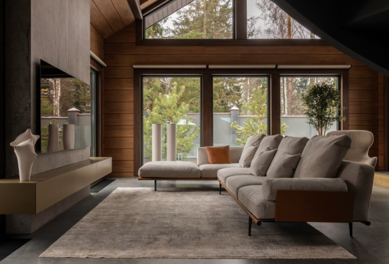Living room - Against the background of the log walls, the construction for a TV panel in porcelain stoneware (Porcelanosa) and the suspended console with bronze facades look elegant. The Poltrona Frau sofa, soft and high-backed, and the Poliform swivel a | courtesy of LINES
