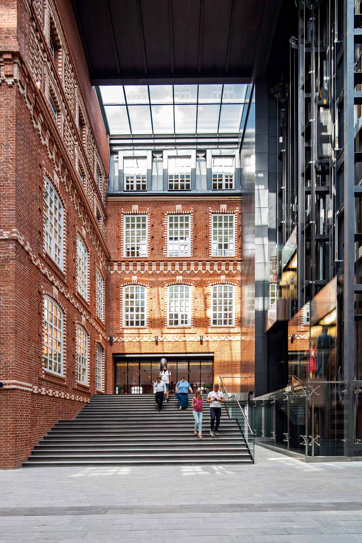 Bolshevik Factory, Moscow, Russia | ohn McAslan+Partners’ Bolshevik Factory transformation includes commercial, residential and cultural spaces within a richly landscaped setting within a series of adapted and extended industrial buildings and glazed internal streets, 2016 © Denis Esakov