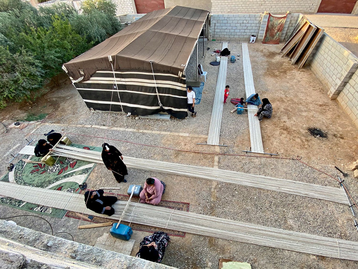 Reviving the Culture of Weaving as a Modus Operandi | Bedouin women from the Al Jafr area carry rolled and easily transportable woven textiles of the Terroir structure, hand-woven using traditional ground looms. © Abeer Seikaly, 2022 Unless otherwise indicated, images courtesy of Abeer Seikaly