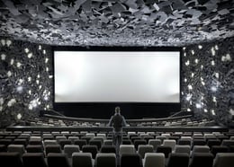 Grey three dimensional square-shaped boxes of sound absorbing materials surround the auditorium | 