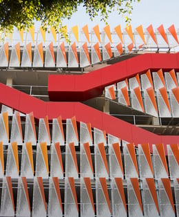 The innovative structure is highly sustainable with exterior staircases and metal façade panels that reflect light into the interior. | 