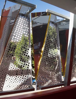The portion of the façade that remains unfolded is perforated to allow for the passage of low angle light directly into the garage and to provide a high degree of visual transparency. | 
