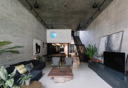 View of living room. The lap pool is suspended over the kitchen. | Marc Tan