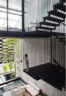 A suspended steel rod staircase forms a key feature in the double volume central atrium. | Fabian Ong