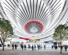 Pedestrians flow in and out of Xiqu Centre’s atrium and naturally-ventilated public plaza beneath the raised Main Auditorium | Ema Peter - Ema Peter Photography: www.emapeter.com