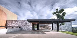 Main entrance which its wall is made of mountain stone. | Depth of Field Co., Ltd