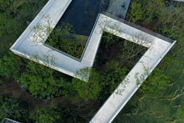 The landscape bridge is built on the hillside wriggled and scattered and integrated with the building. Visitors can feel the wild pleasure of walking through the trees. | Prixm Images