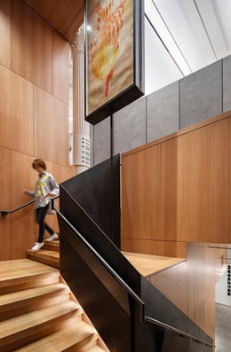 Descending to the basement, a staircase combines rift-sawn white oak with chemically blackened steel. | Photography, Michael Moran / OTTO