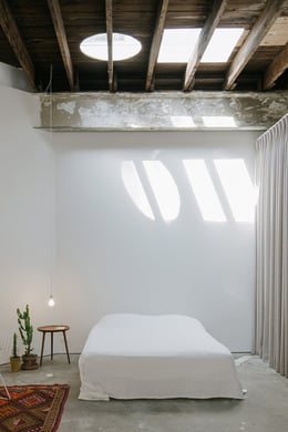 Photograph showing main bedroom space with new toplights. The original structure - the joists - were not cut for the skylight installation. | Florian Holzherr