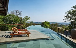 The elevated pool (sleeping spaces below it) extends into the  Forest and connects to the hills beyond | Bharath Ramamrutham