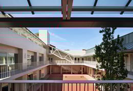The courtyard conjures up an inner world in which to learn and play. The walls are sheltered by canopies and lined with light ivory glazed brickwork that illuminates the space | Nick Kane