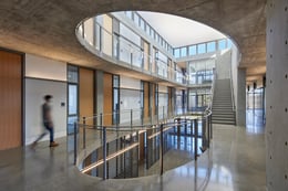 A spare material palette—metal, concrete, gypsum and wood—unifies the light-filled interior. | Photo © Bruce Damonte