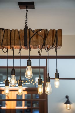 Reclaimed wooden rafters used as light fixtures. | Noughts and Crosses © Andre J. Fanthome