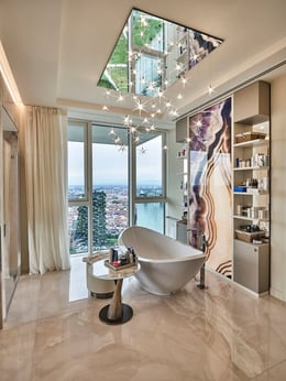 In the master bathroom, the boundaries between indoor and outdoor dissolve, evoking the sensation of being cocooned beneath a soothing cascade under the glow of starlight. | Matteo Imbriani