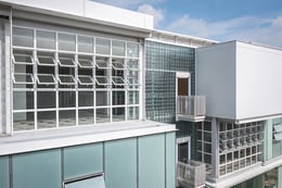 Building Exterior : Modern architectural facade featuring glass blocks and a fresh, clean aesthetic, integrates seamlessly into the urban environment. | © Spaceshift Studio