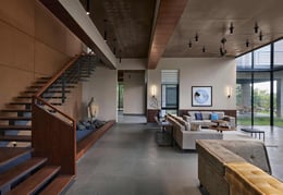 The double volume living area maximises the light coming into the space and the study on the top overlooking into the living area breaks the mass and increases internal visual connection. One of the two staircase connects ground and first floor. | Isha Shah