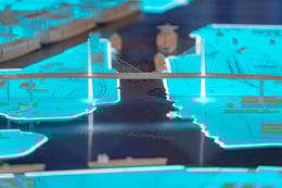The large-scale illuminated 3D map table at the Port of Long Beach exhibition space offers a captivating and educational experience. Visitors can explore intricate details, such as the Long Beach International Gateway Bridge, gaining a tangible understand | Paul Vu