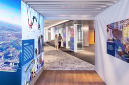 As you step inside the container exhibit, which highlights the Port's dedication to its community, your gaze is drawn to a striking black ribbon that cascades through the space. This leads to the Innovations Exhibit, where 3D models showcase the Port’s gr | Paul Vu