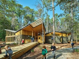 A gentle, universally accessible walkway invites children and adults to the explore the building nestled in nature. | Timothy Hursley