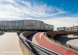 The frontal view of the Arena is the first image that greets visitors upon entering ChorusLife. Its dynamic aluminum skin is made up of hinged and perforated silver panels, alternating between glossy and matte finishes, allowing the façade to shimmer and  | JDParchitects