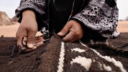 Reviving the Culture of Weaving as a Modus Operandi | Matters of Time. Video still. A Bedouin woman’s skilled hands bring a tent to life, her voice filling the air with traditional songs in Jordan’s Wadi Rum desert. © Abeer Seikaly, 2019