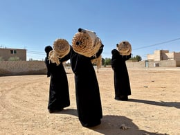 Reviving the Culture of Weaving as a Modus Operandi | Bedouin women from the Al Jafr area carry rolled and easily transportable woven textiles of the Terroir structure, hand-woven using traditional ground looms. © Abeer Seikaly, 2022 Unless otherwise indicated, images courtesy of Abeer Seikaly