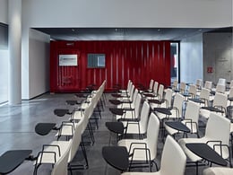 Mozzanica & Mozzanica Headquarters - Maurizio Montagna, courtesy of Alessandro Villa studio | On the side of the auditorium is a red container equipped with fire extinguishers. Thanks to the openable windows, it can be moved within the room for tests and demonstrations.