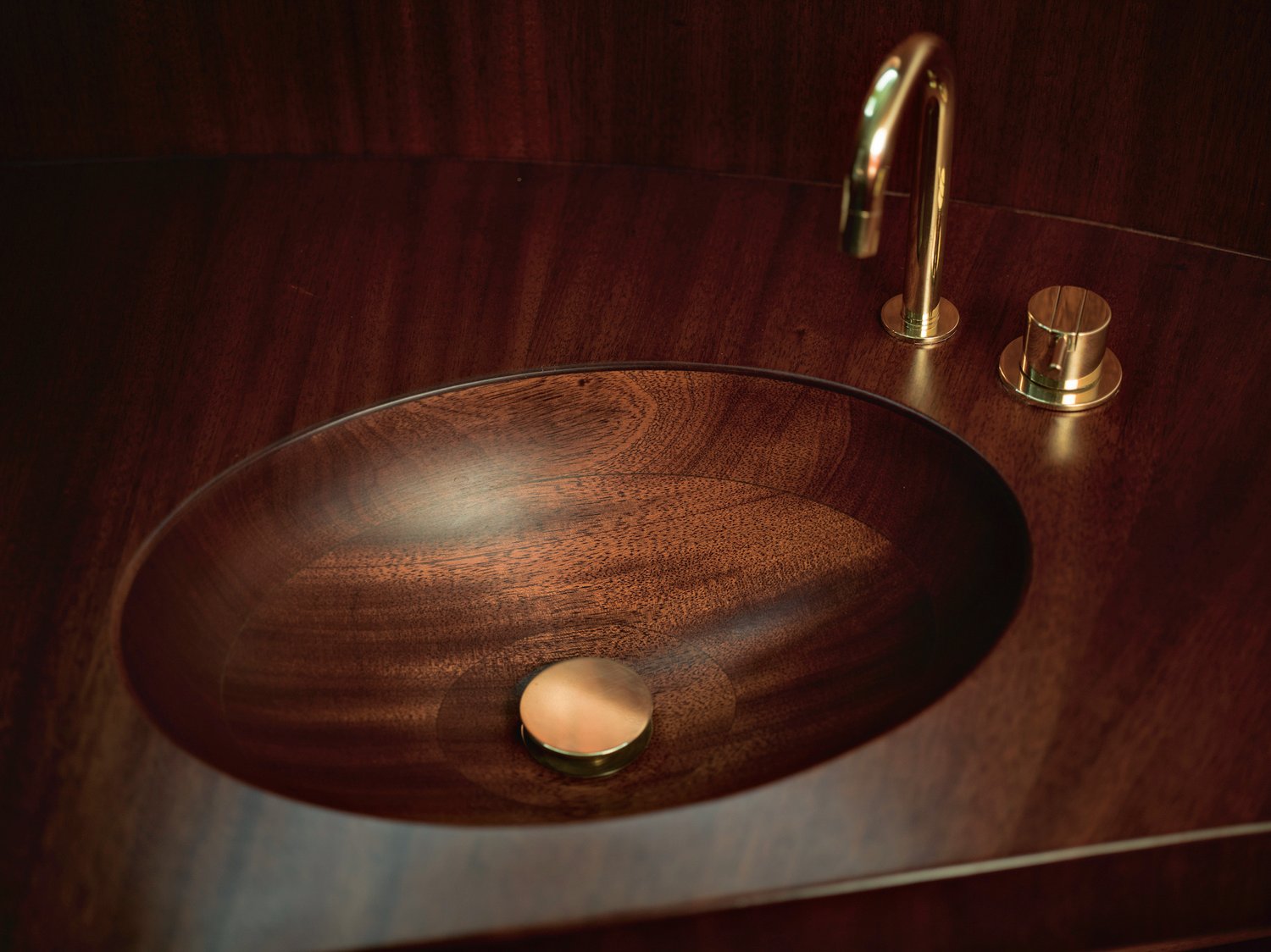 Courtesy Waterline Media | All bathrooms have rounded solid wood sinks built into countertops, plus power showers